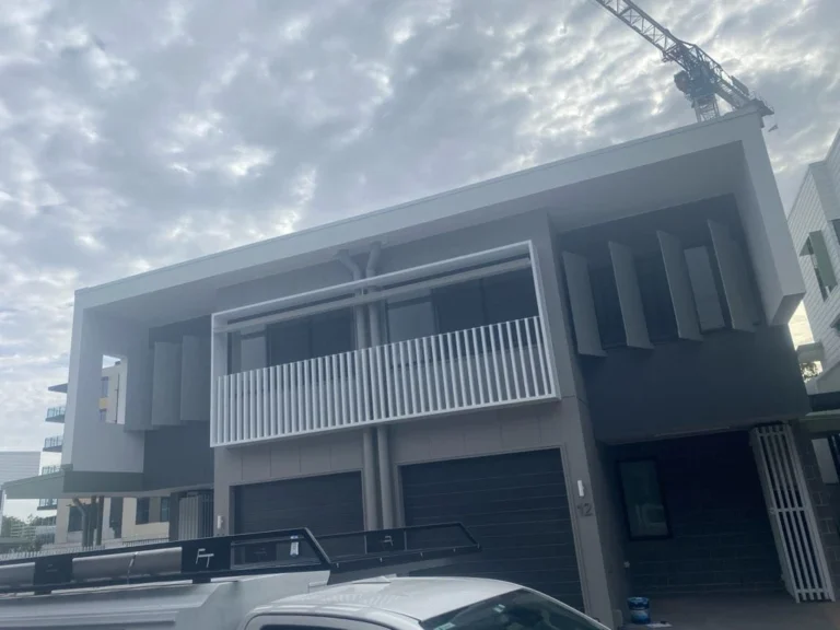 Two-storey townhouse exterior with white balcony screen, painted by Austa Painting & Decorating