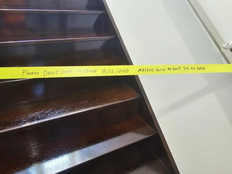 Close-up of glossy dark timber stair treads after a fresh coat